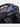 Black backpack with a passport inside on a white background with brand emmeton