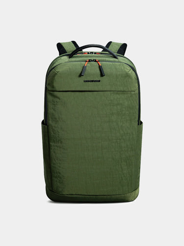 Green backpack with black straps on a light gray background