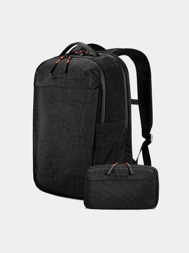 Black backpack with a smaller black pouch on a light gray background
