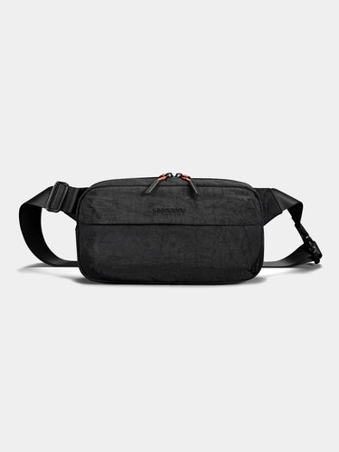 Black sling cross-body bag on a light gray background