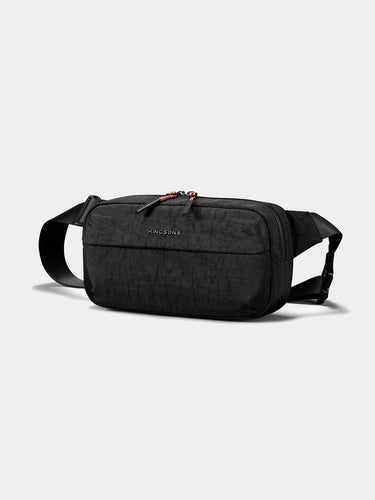 Black sling cross-body bag on a light gray background