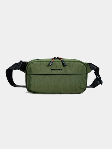 Green sling cross-body bag on a light gray background