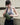 Woman holding a green waist bag against a neutral background