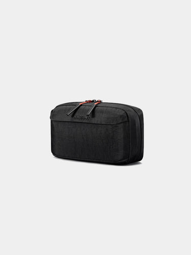 Black tech bag with red zipper on a light gray background