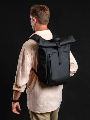 Man wearing the Venture Fold-Top Pack 18L in black