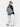 Person wearing a green backpack on a white background