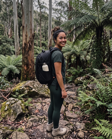 Woman wearing the Metro Anti-Theft Pack 20L in black on a rainforest trail
