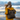 Person wearing a yellow raincoat and brown backpack standing on a beach with a cloudy sky.