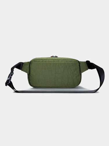 Green sling cross-body bag on a light gray background