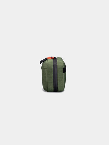 Green bag with black strap on a white background