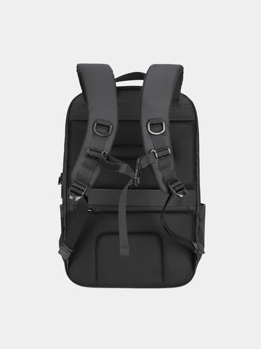 Black backpack with multiple straps on a light gray background
