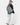 Person wearing a green backpack on a white background