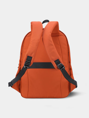 Red / Orange backpack with black straps on a light gray background
