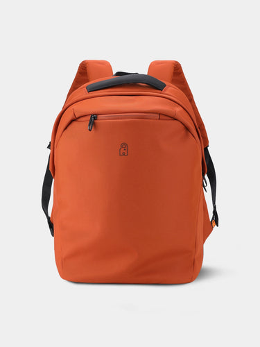 Red / Orange backpack with black straps on a light gray background
